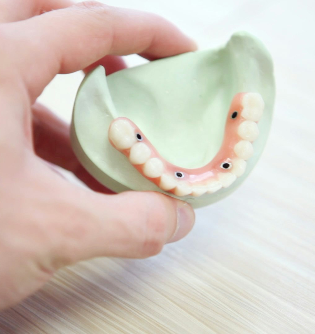person holding teeth